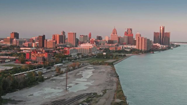 Aerial: Detroit city skyline and the Detroit river at sunset. Detroit, Michigan, USA