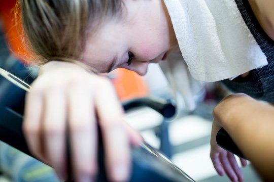 Woman resting her head in gym