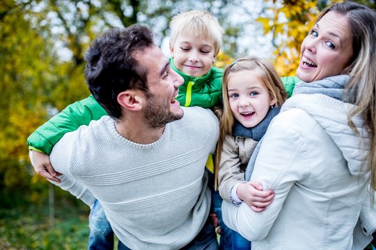 Family Enjoying In Autumn