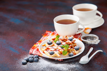 Homemade wafers with berries and tea on a table. Selective focus. Copy space.