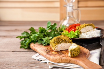 Chicken fillet in a green breading with a garnish. Selective focus. Copy space.