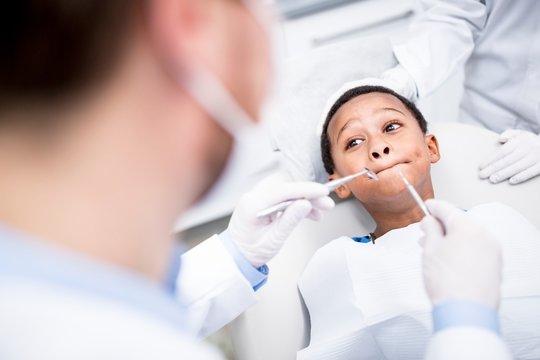 Boy rejecting dental treatment