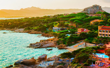 Landscape and scenery of Baja Sardinia luxury resort in Costa Smeralda at sunset evening, Sardegna island in Italy in summer. Olbia province. Villas And Mediterranean sea. Mixed media.