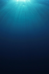Underwater ocean blue background vertical photo 