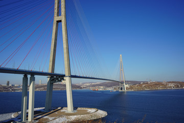 Landscape with a view of the Russian bridge against the blue sky.