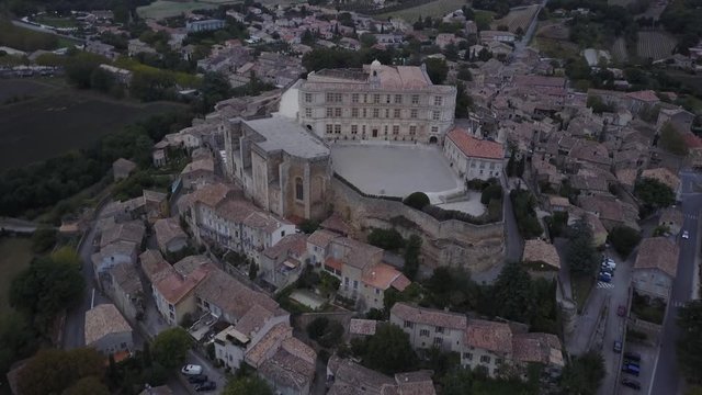 Aerial pan left Grignan village in provence at sunrise from above france