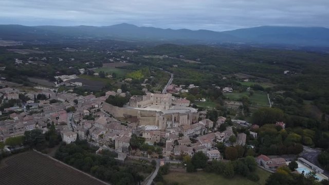 Aerial pan left Grignan village in provence at sunrise from above france