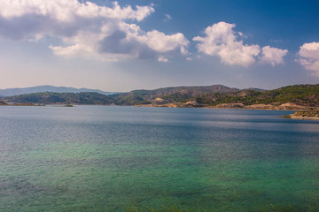turquoise lake surrounded by mountains on the island of Rhodes