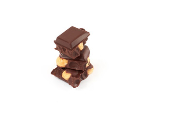Chocolate pieces with nuts isolated on white background