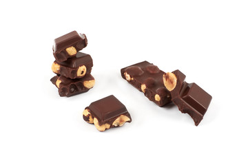 Chocolate pieces with nuts isolated on white background