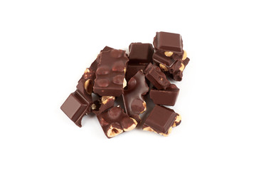Chocolate pieces with nuts isolated on white background