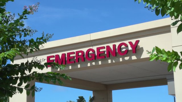 Emergency room exterior sign on a windy day.