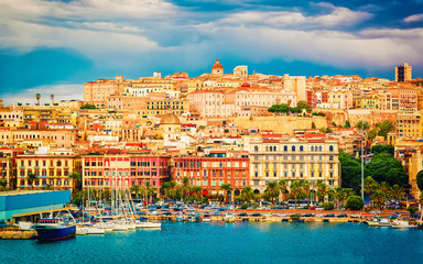 Old Sardinian Port with ships at Mediterranean Sea and city of Cagliari, South Sardinia Island in...