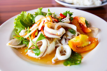 Spicy squid salad with tomato and mix vegetables.