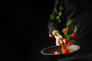 Seafood, Professional cook prepares slices of red fish, salmon, trout frying in a pan with greens, parsley. Seafood cooking, healthy vegetarian food and food on a dark background, banner