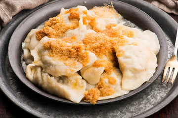 Boiled pierogi (Polish dumplings) stuffed with cabbage and mushrooms