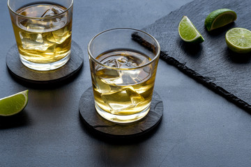 Scotch - two glasses with ice - on black background
