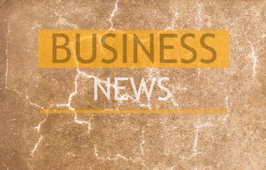 Fototapeta premium stone wall background with the inscription business news.