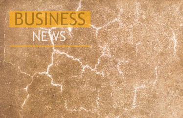 stone wall background with the inscription business news.