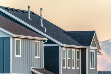 Grey timber house facade at sunset day light
