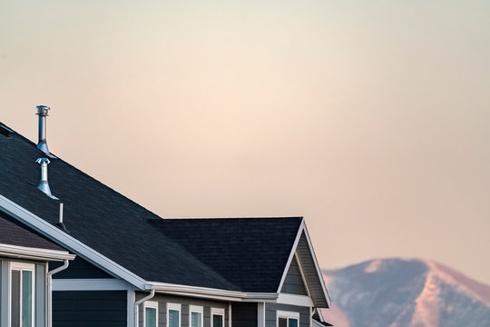 Cropped image of a house and mountain peak