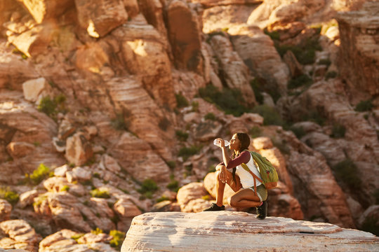 woman hiker at red rock canyon drinking from water bottle