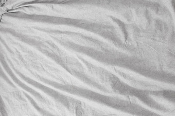 Fototapeta na wymiar background from gray linen bed sheet surface