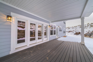 Wooden deck on a covered exterior patio in winter