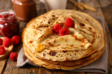 stack of crepe with raspberry and chocolate - obrazy, fototapety, plakaty