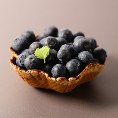 biscuit bowl with blueberry on grey background