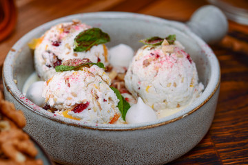 Traditional Georgian ice cream dessert. Nakhini salted caramel ice cream with candied fruits and nuts served in a bowl