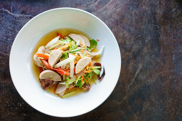 Delicious spicy vietnamese sausage salad on white plate