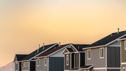 Panorama Row of grey house facade with white accents © Jason