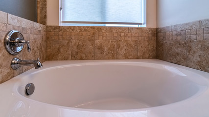 Panorama frame Small bathtub with mixer tap on wall