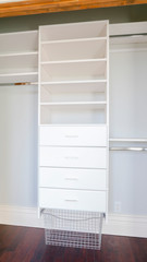Vertical Empty shelves of a luxury walk-in closet