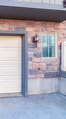 Fototapeta na wymiar Vertical Automated garage door of a brick house