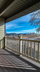 Fototapeta na wymiar Vertical frame Wooden patio deck overlooking countryside day light
