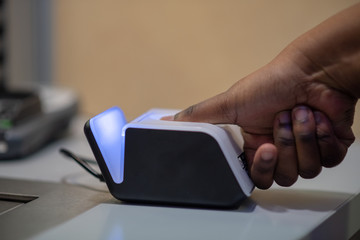 Finger being scanned on reader 