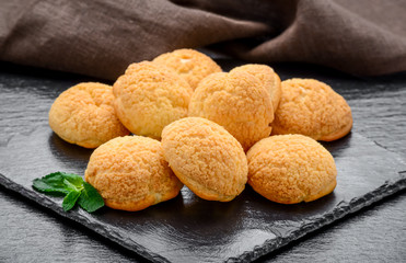 Amaretti cookies in a glass bowl on old wooden background