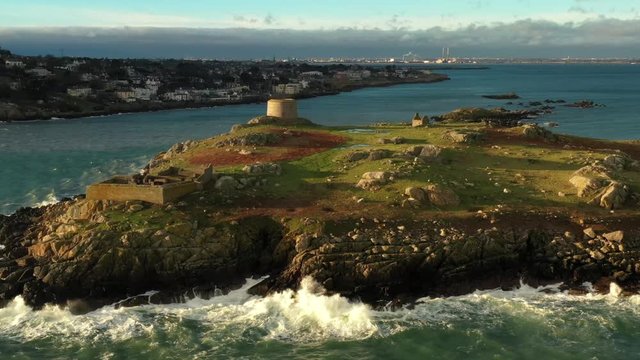 Dalkey Island, Dublin, Ireland, January 2020, Drone pulling back revealing Fort, Martello Tower and St. Begnet's Church