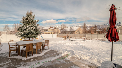 Panorama Swept exterior patio with garden in winter snow