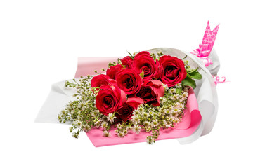 Red roses bouquet wrapped in paper with a pink ribbon
