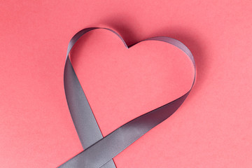 Heart shaped ribbon on a pink background. Valentine's Day Gift