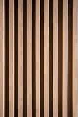 Close up vertically Texture of Large Brown decorative wooden battens wall pattern background.