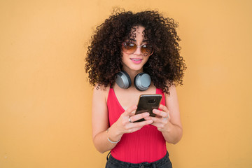 Afro woman using her mobile phone.