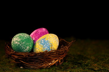 beautiful multicolored Easter eggs in a wicker basket 