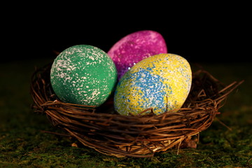 beautiful multicolored Easter eggs in a wicker basket 
