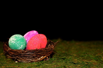 beautiful multicolored Easter eggs in a wicker basket 