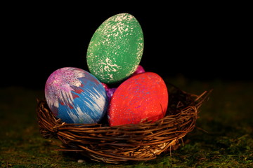 beautiful multicolored Easter eggs in a wicker basket 