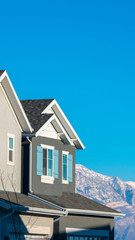 Vertical frame House facades and snowy mountains in Utah Valley